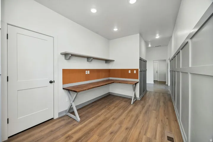 Unfurnished office with dark wood finished floors and recessed lighting