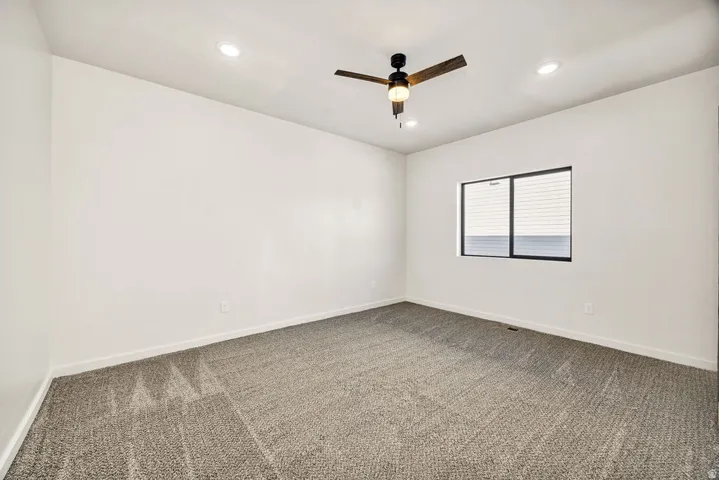 Unfurnished room with carpet floors, ceiling fan, and recessed lighting