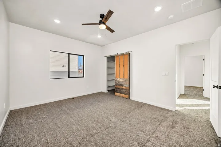 Unfurnished bedroom featuring carpet floors, ceiling fan, and recessed lighting