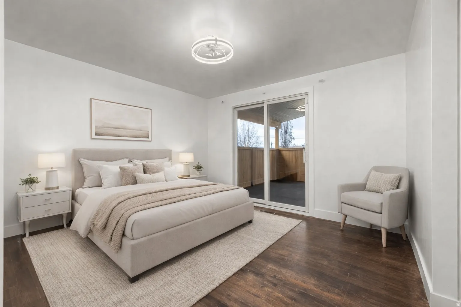 Bedroom with dark wood finished floors and access to exterior