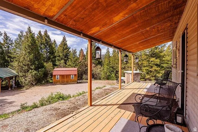 Wooden deck featuring an outbuilding