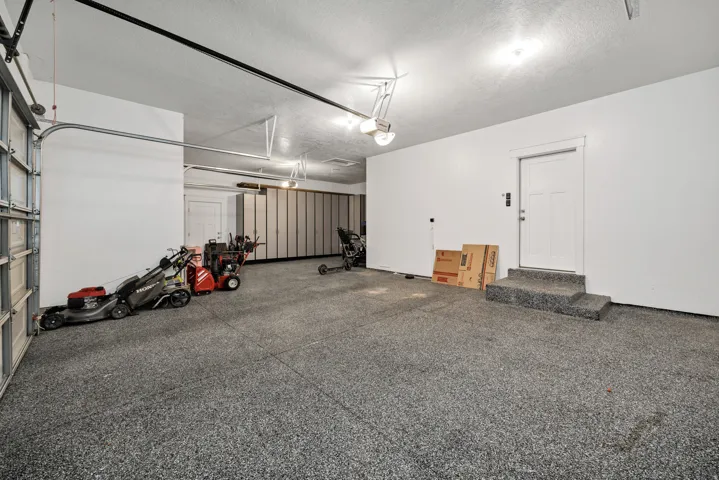 Garage featuring a garage door opener