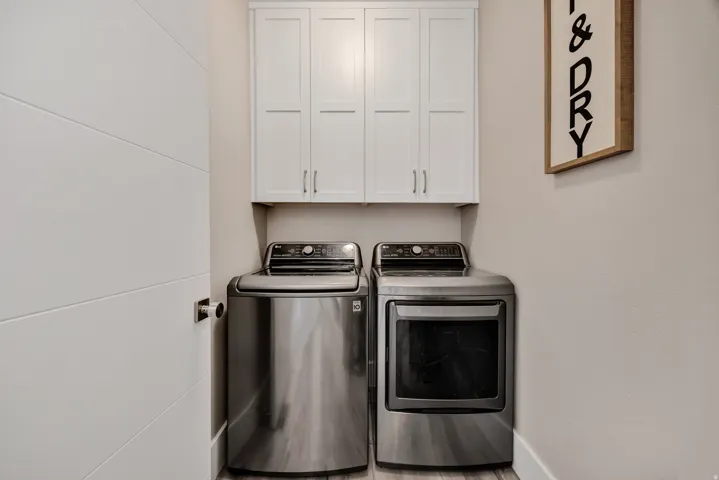 Laundry room with cabinet space and independent washer and dryer