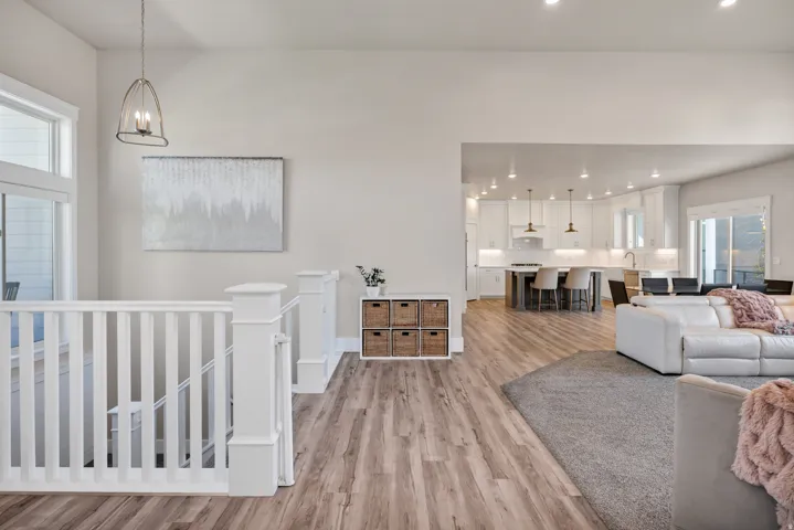 Living room featuring light wood finished floors and suspended lighting