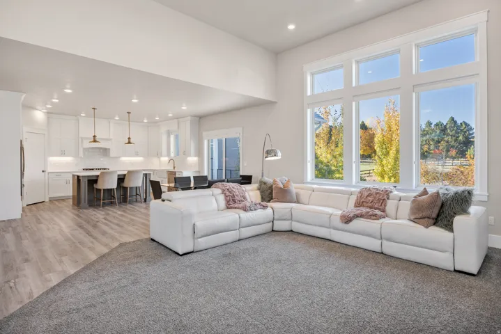 Living area with plenty of natural light, recessed lighting, and light wood-type flooring