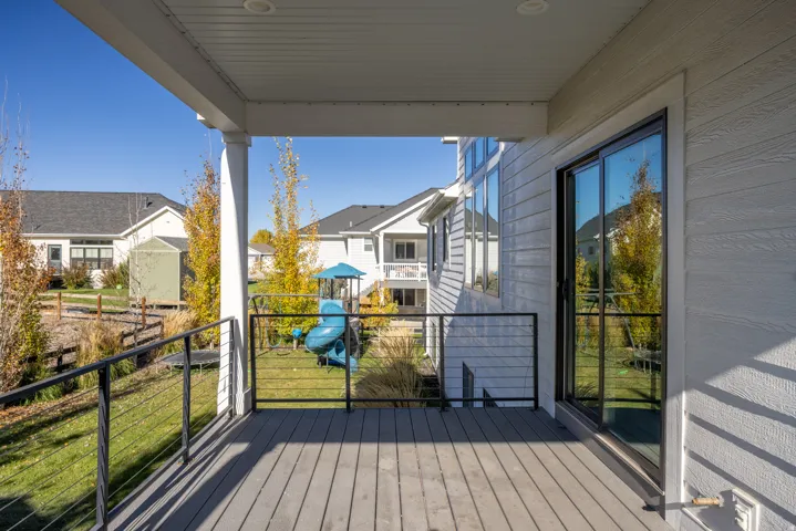 Wooden deck with a playground and a lawn