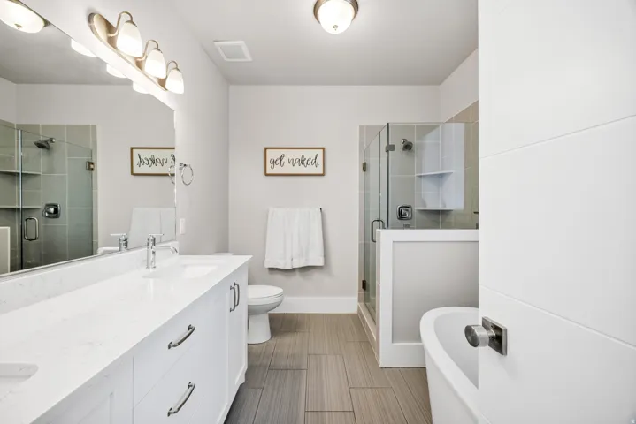 Bathroom with a freestanding bath, double vanity, and a shower stall