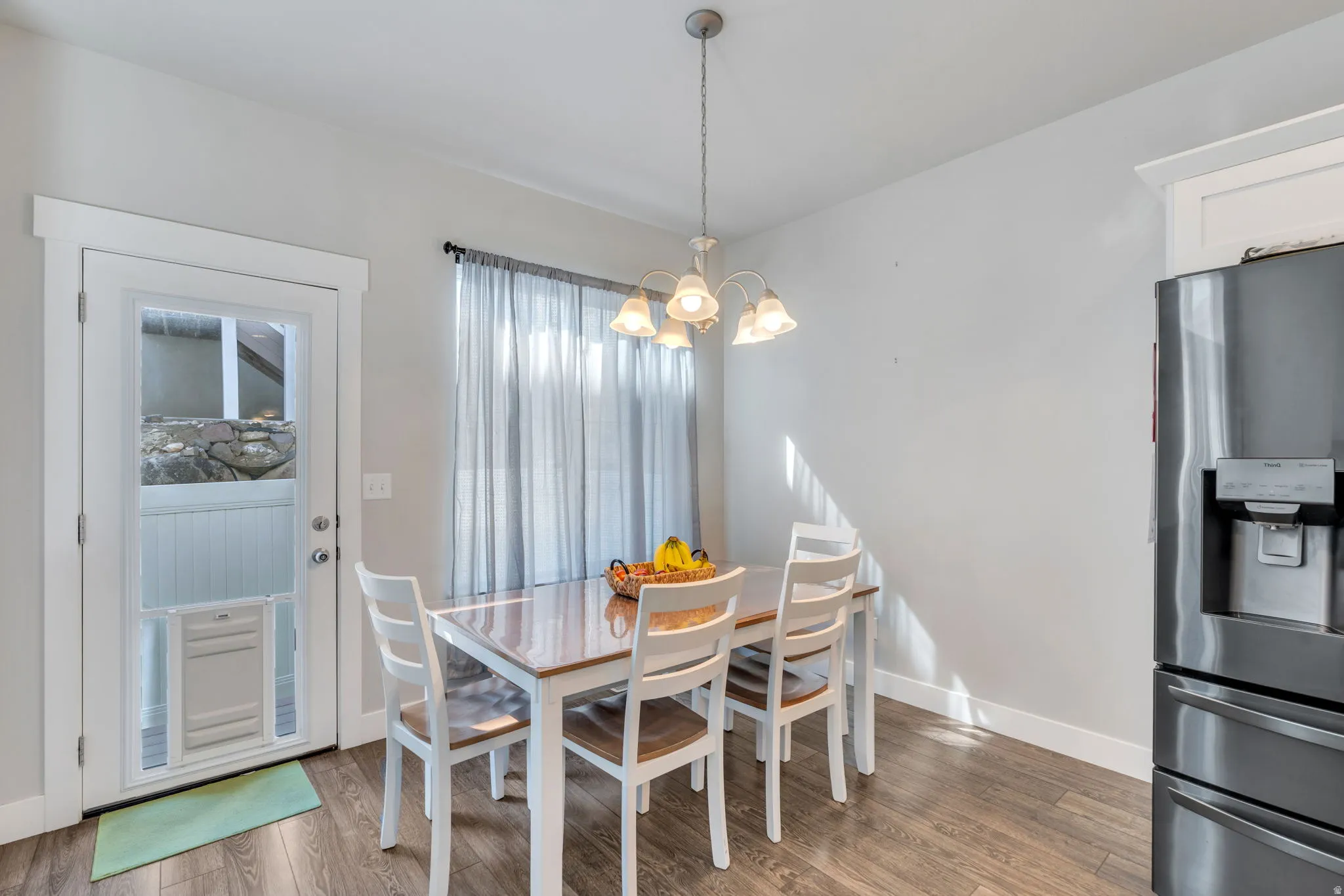 Dining room featuring suspended lighting and light wood-style floors