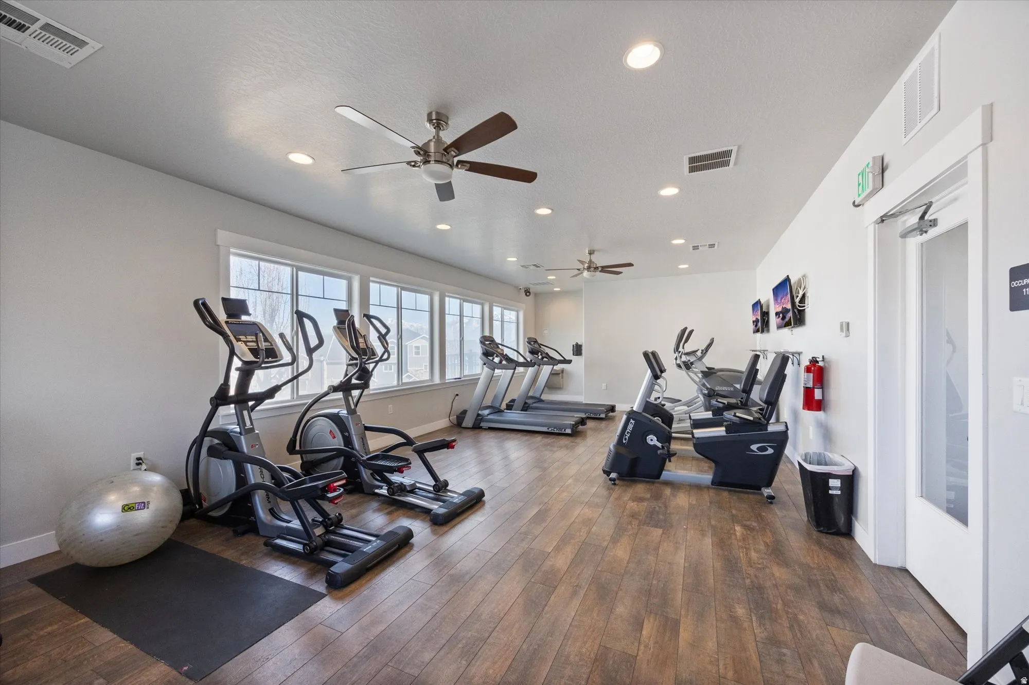 Gym featuring recessed lighting and a ceiling fan