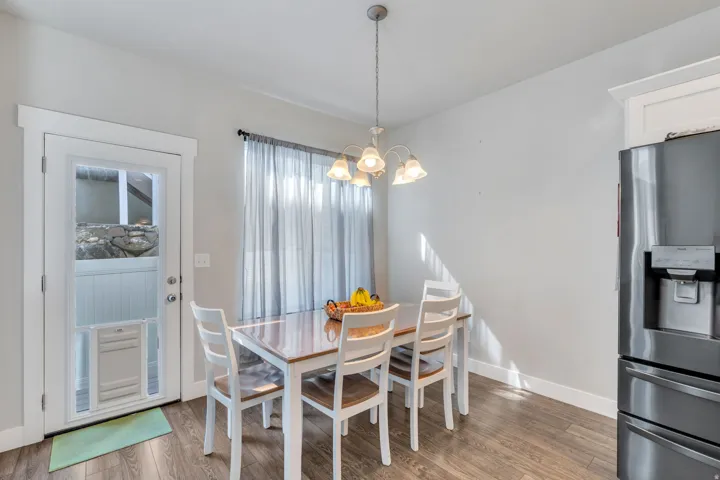 Dining room featuring suspended lighting and light wood-style floors