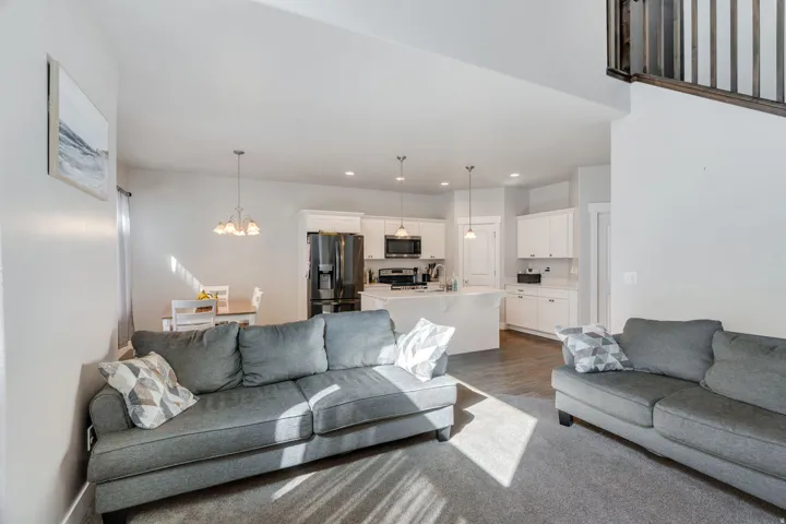 Living room featuring suspended lighting and wood finished floors