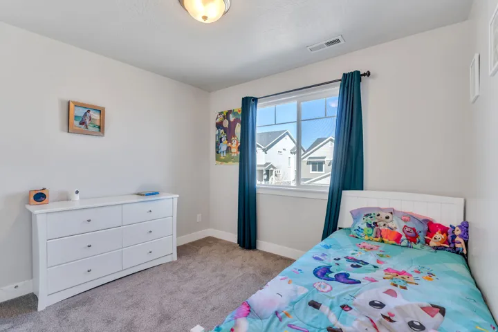 Bedroom with baseboards and light carpet