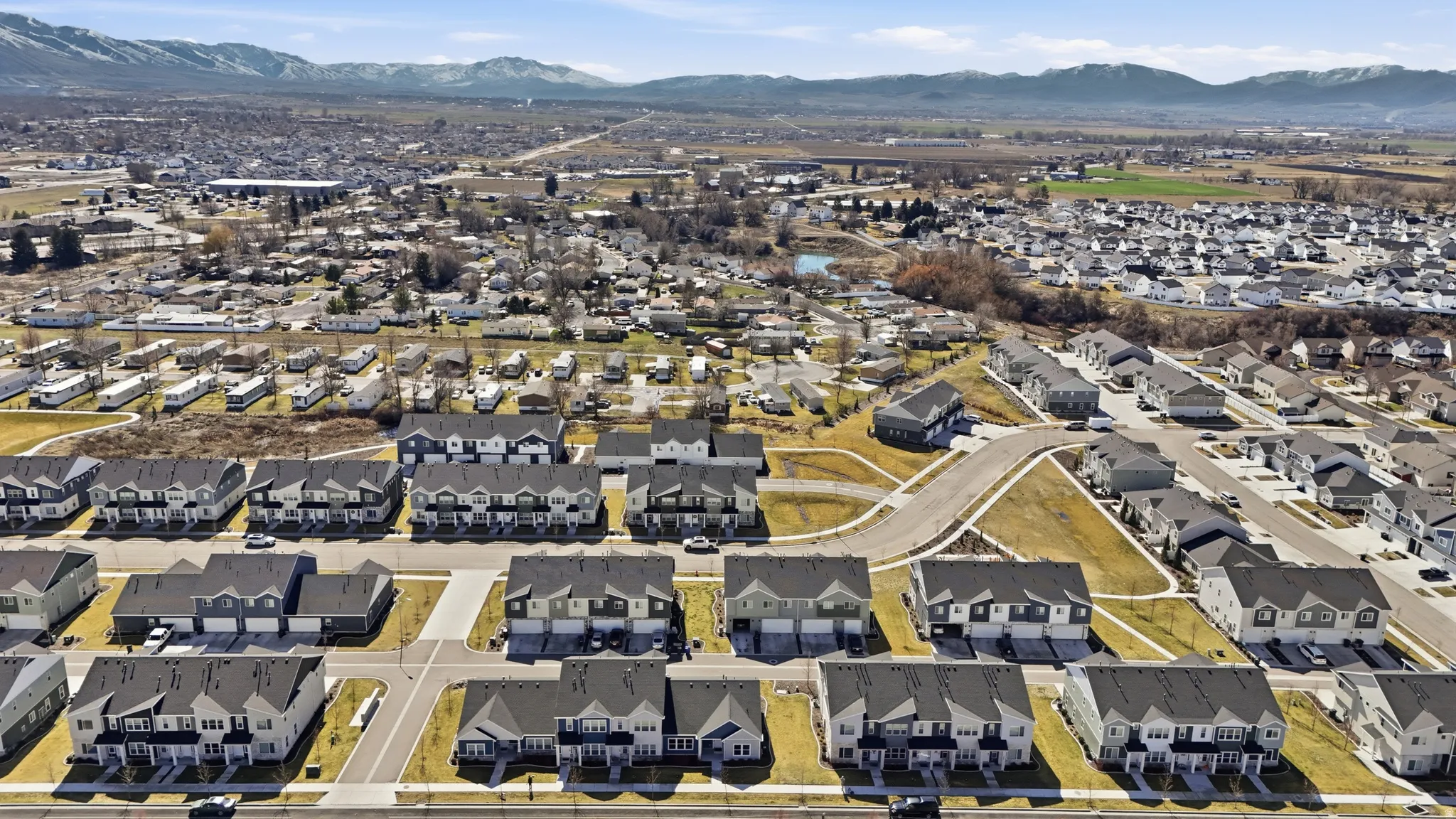 Aerial overview of property's location featuring nearby suburban area and a mountainous background