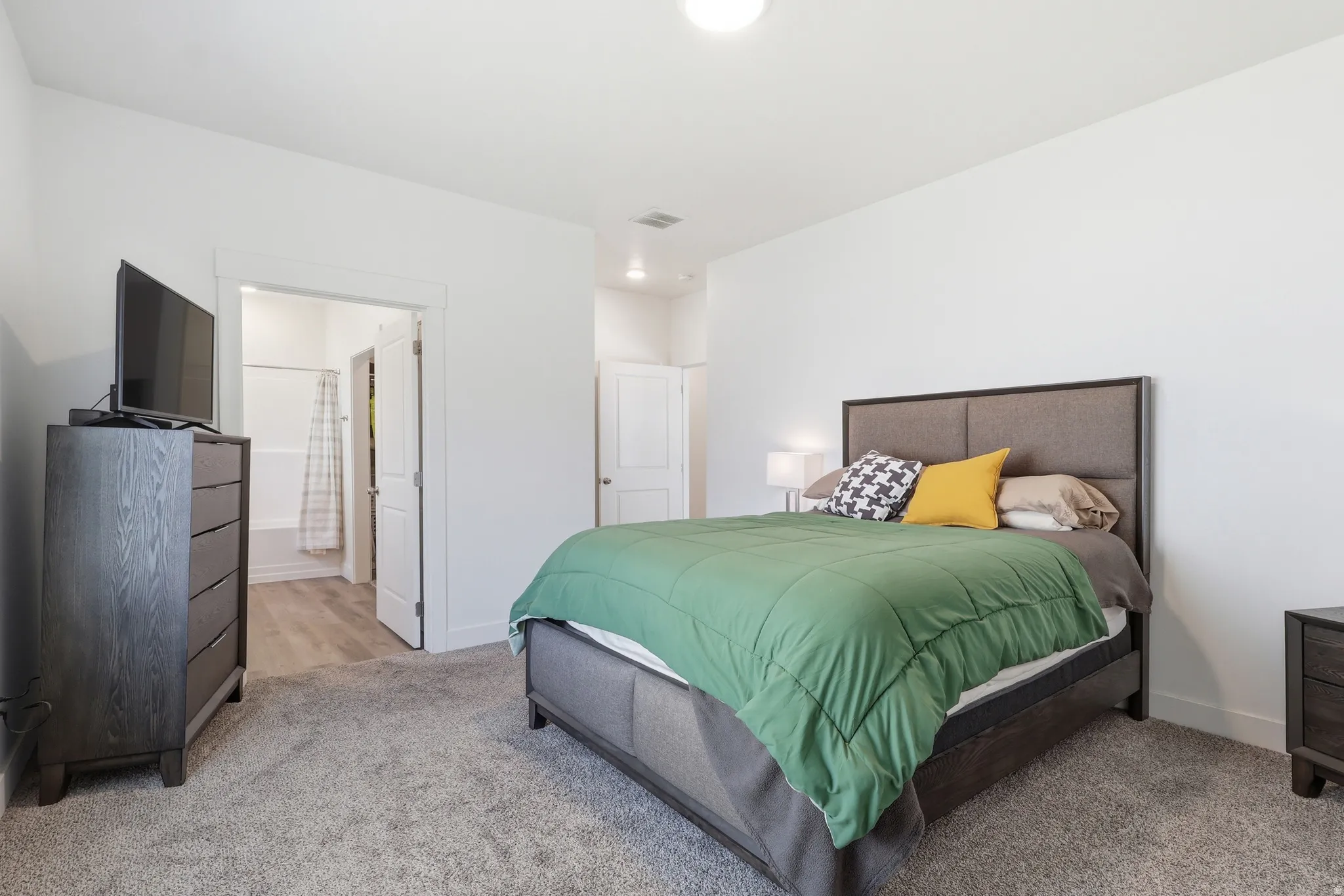 Primary Bedroom featuring connected bathroom