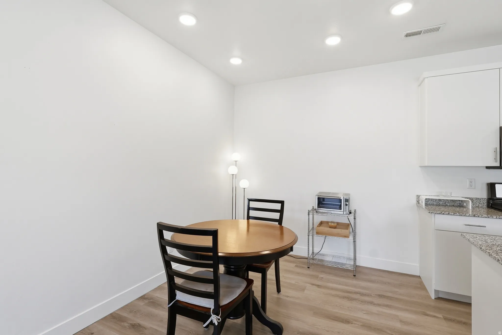 Dining space featuring light wood finished floors and recessed lighting
