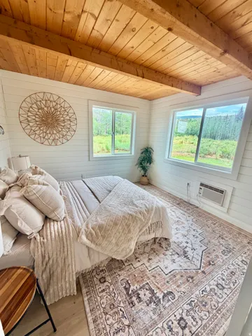 Exposed wood beam ceiling with natural wood planking