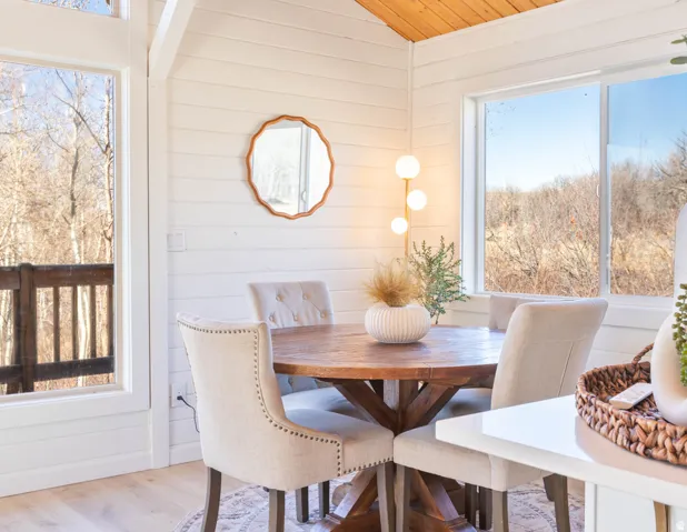 Dining room with wood finished floors, wooden walls, and a vaulted wooden ceiling