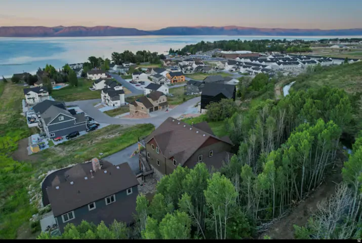 Aerial view at dusk of a water view and a residential view