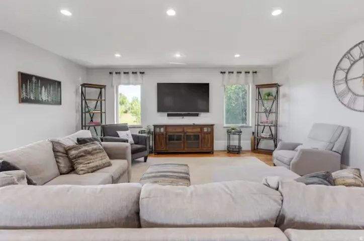 Living area featuring healthy amount of natural light, recessed lighting, and light wood-style flooring
