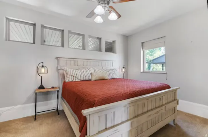 Bedroom with ceiling fan and carpet flooring