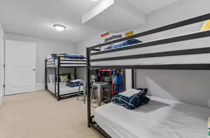 Bedroom featuring light colored carpet and baseboards