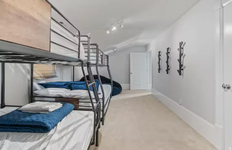 Bedroom featuring vaulted ceiling and light carpet