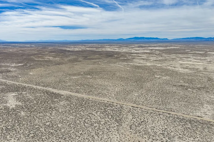 Aerial view of sparsely populated area with a mountain backdrop
