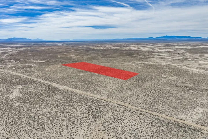 Aerial view of sparsely populated area with mountains and a desert landscape