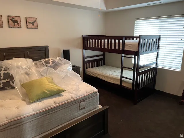 Carpeted bedroom featuring baseboards