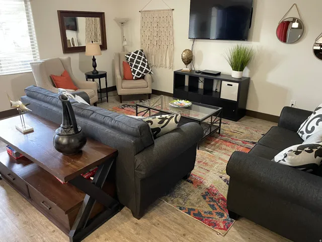 Living area with baseboards and light wood-type flooring