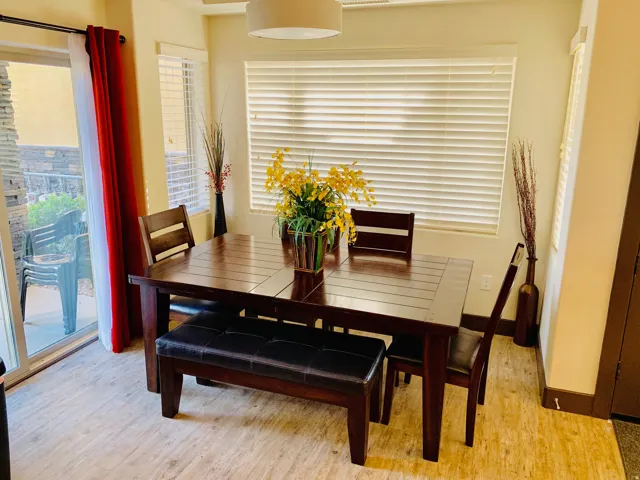 Dining area with light wood-style floors and baseboards