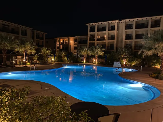 Pool at twilight featuring a community pool and a patio