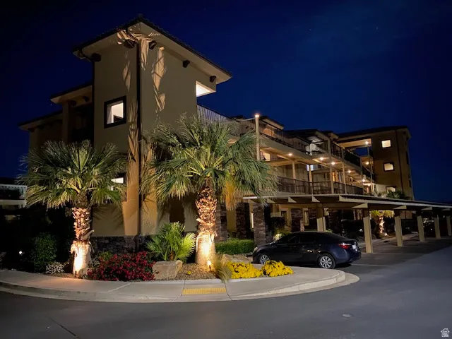 Property at night with a view of apartment building / complex