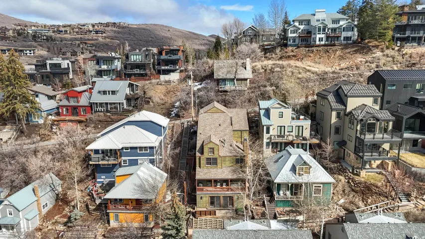 Aerial perspective of suburban area featuring a mountainous background