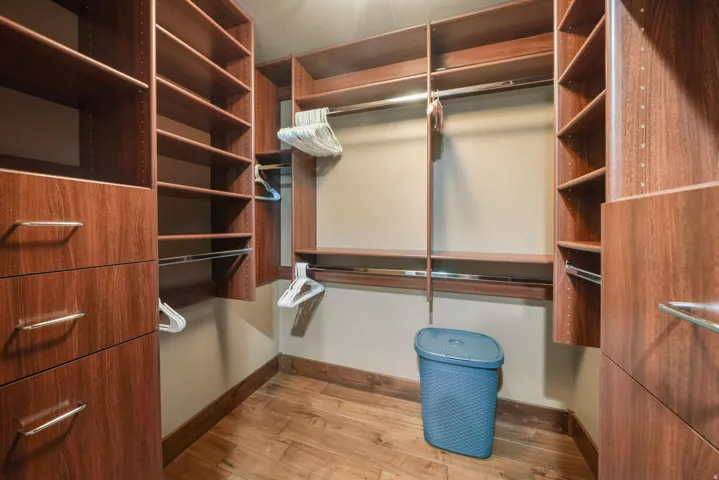 Walk in closet featuring light wood-style floors