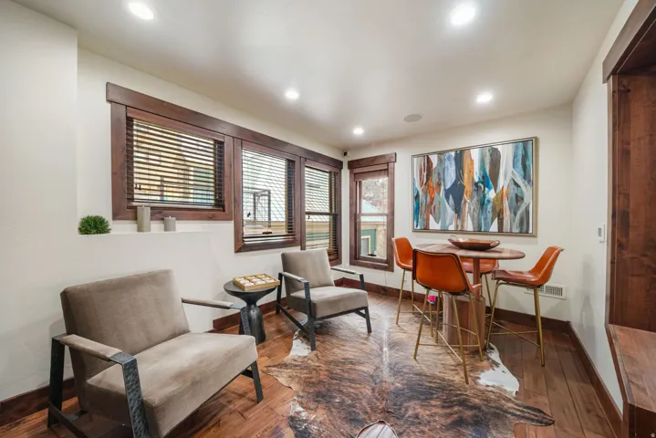 Living area featuring wood-type flooring and recessed lighting