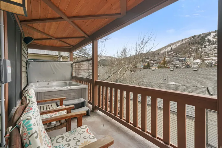 Balcony featuring a mountain view and a hot tub