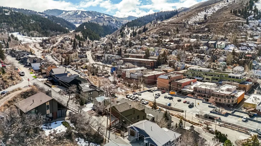 Aerial overview of property's location featuring a mountainous background and nearby suburban area