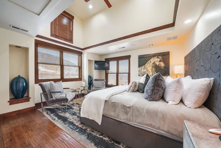 Bedroom with wood-type flooring and a ceiling fan
