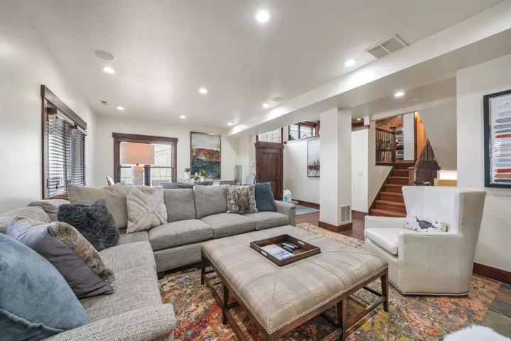 Living room featuring recessed lighting and stairway