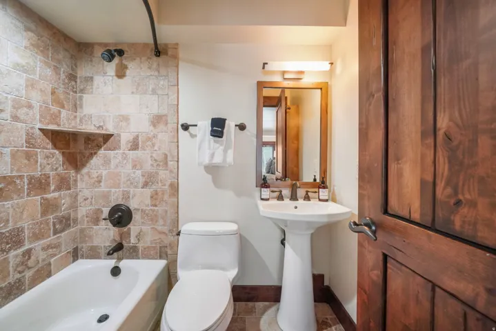 Bathroom featuring toilet and shower / bathtub combination