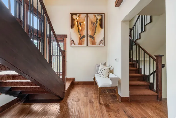 Stairway featuring hardwood / wood-style floors and baseboards