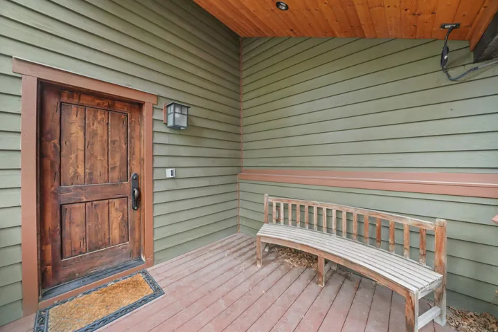 Doorway to property with a wooden deck