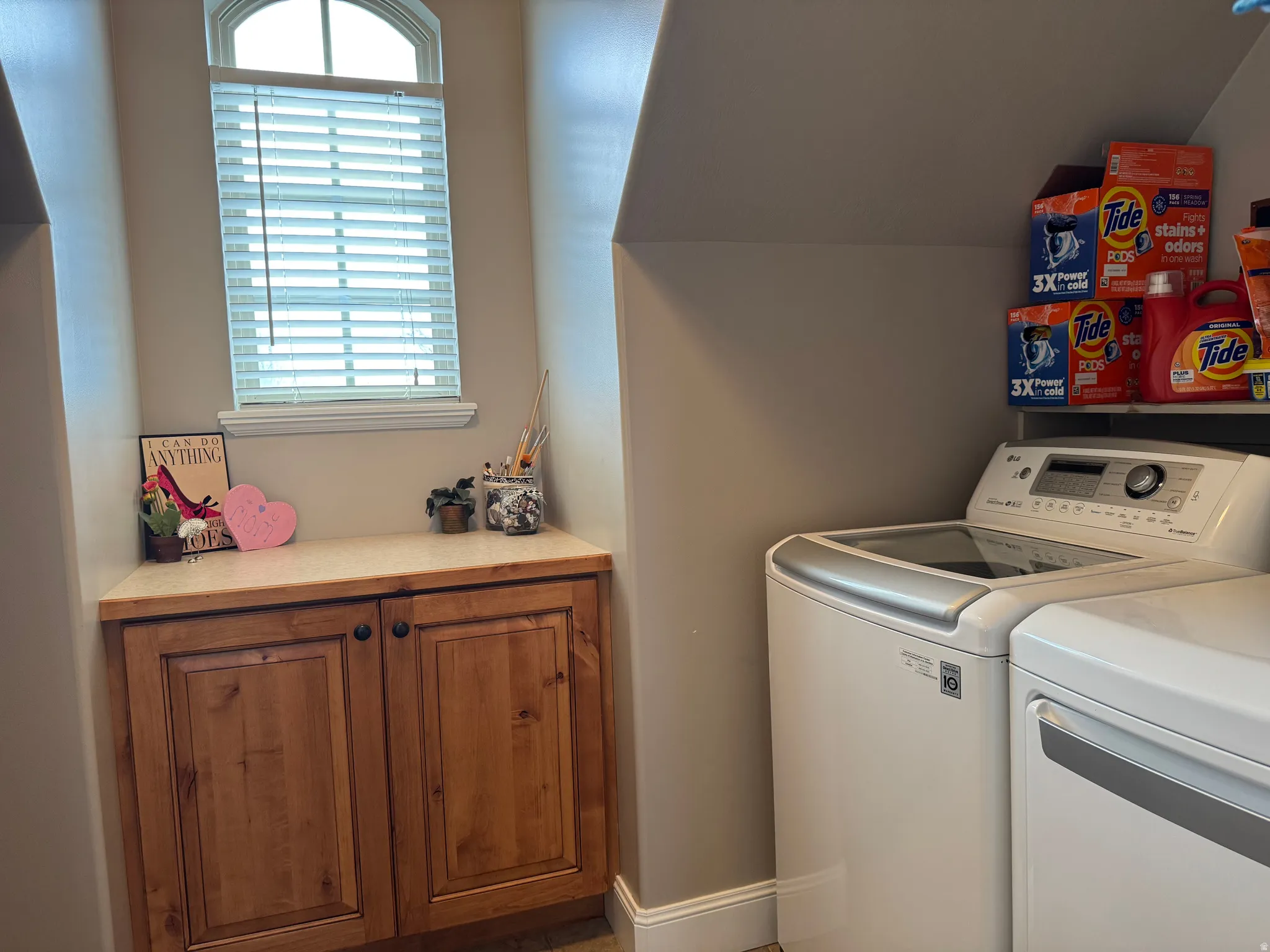 Laundry area featuring washer and dryer, plenty of natural light, and vaulted ceiling