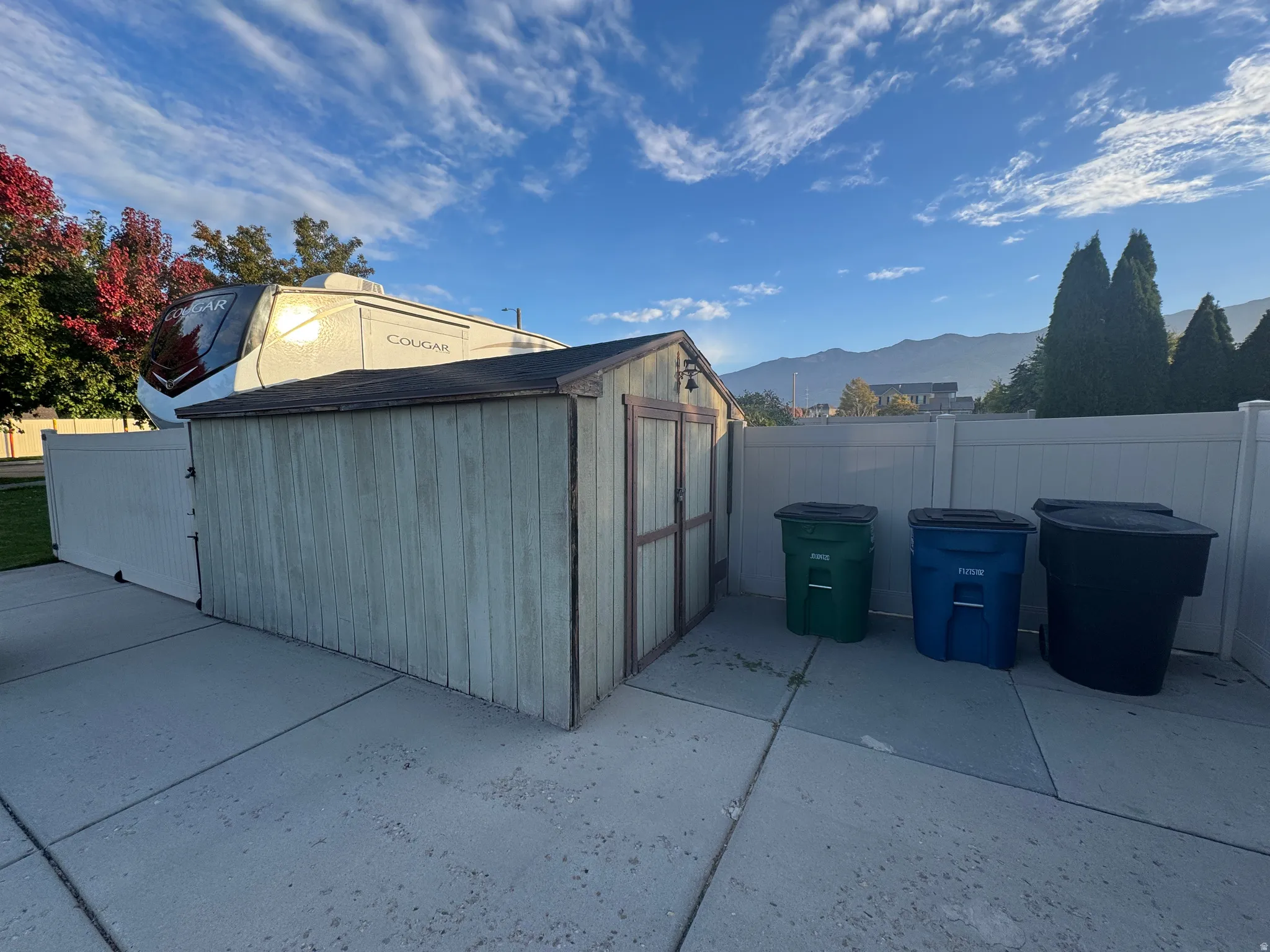 View of shed with a mountain view and a fenced backyard