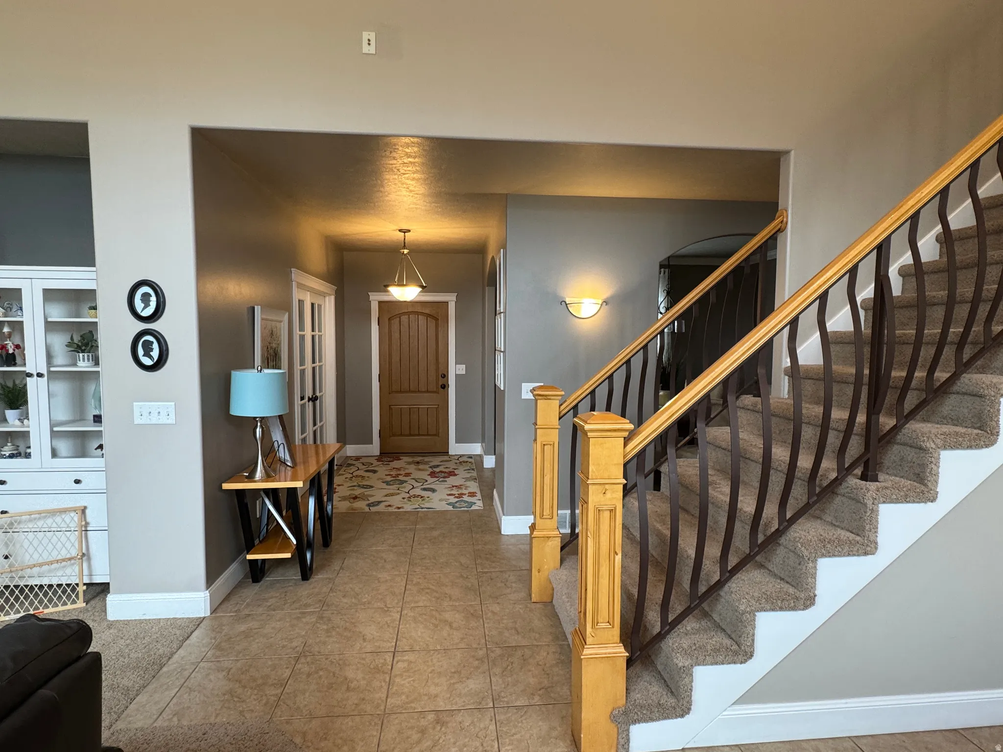 Entryway featuring stairway and light tile patterned floors