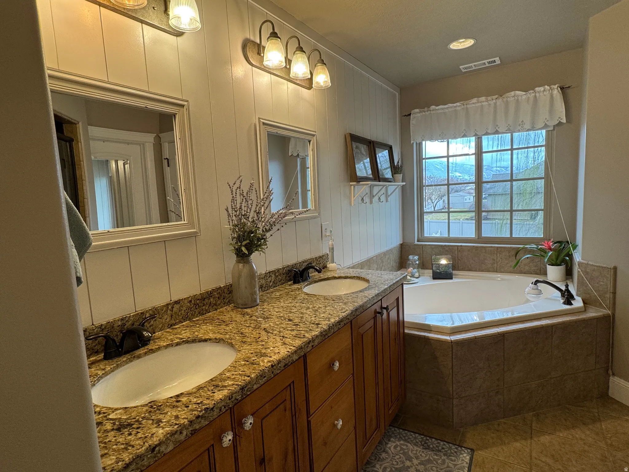 Full bath with double vanity, a bath, light tile patterned flooring, and recessed lighting