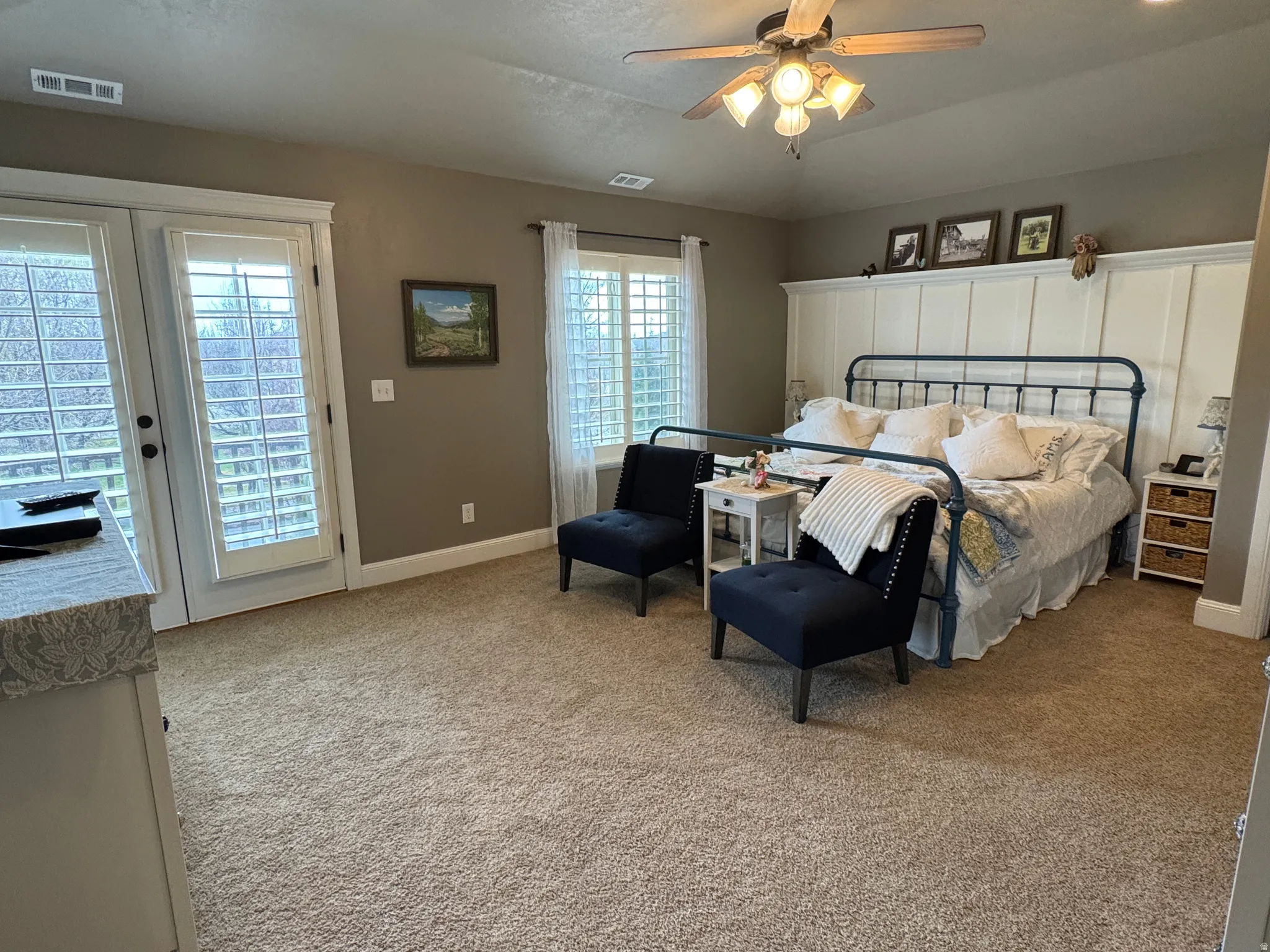 Bedroom with access to outside, light colored carpet, and a ceiling fan