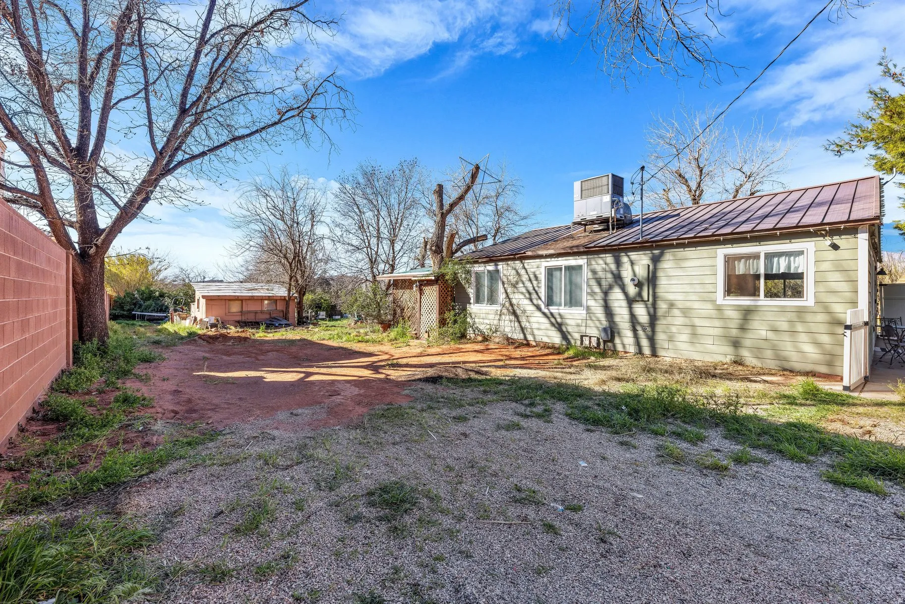 Rear view of house featuring a standing seam roof