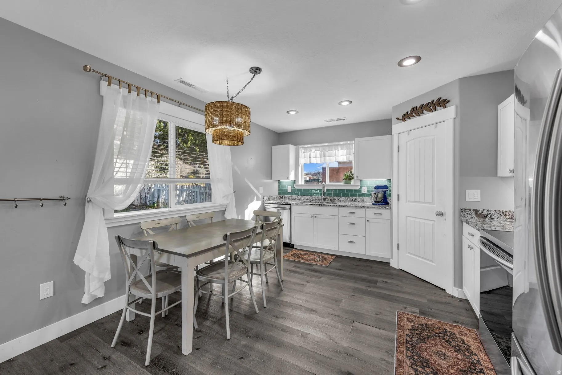 Dining area featuring dark wood-style flooring and recessed lighting